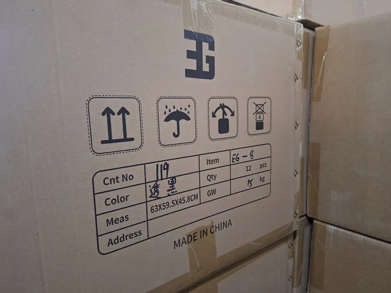 Side view of carton showing all four standard international symbols: Fragile, Keep Dry, This Side Up, and Handle With Care